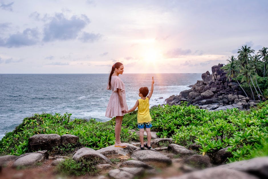 A mother and her son stand by the ocean enjoying a beautiful sunset at Unawatuna, Sri Lanka.