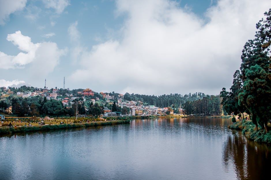 Idyllic lakeside view with charming village and lush greenery, offering a peaceful escape.