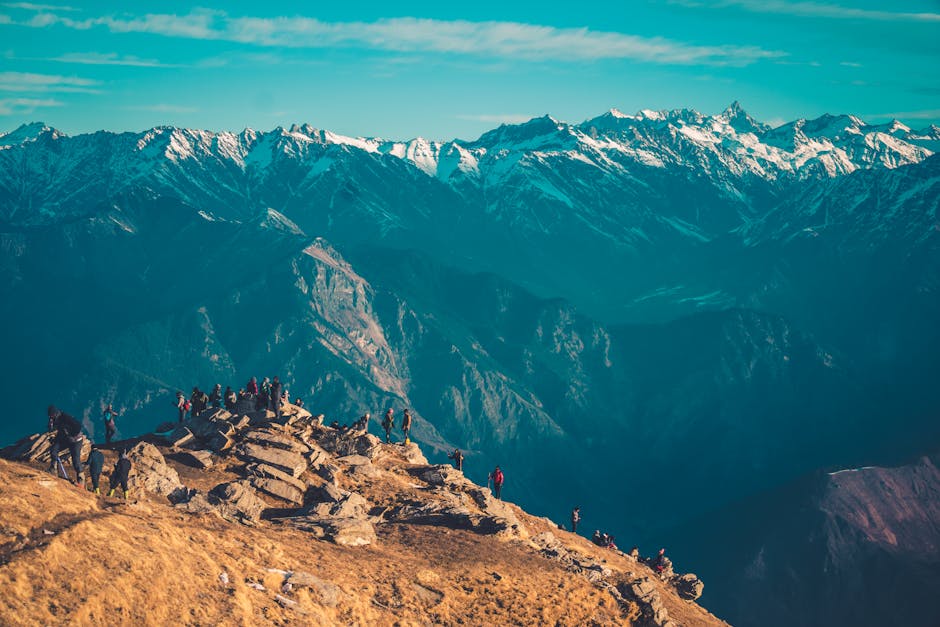 A group of hikers enjoying a scenic view of the majestic Himalayan mountain range on a clear day.