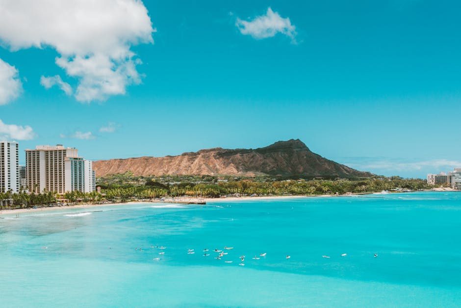 A stunning aerial shot of Waikiki Beach with Diamond Head in the background, showcasing turquoise waters.