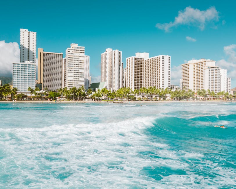 Stunning view of a tropical cityscape with turquoise sea and vibrant summer vibes.