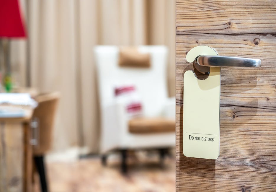 A hotel room door with a 'Do Not Disturb' sign, evoking a sense of privacy and relaxation.